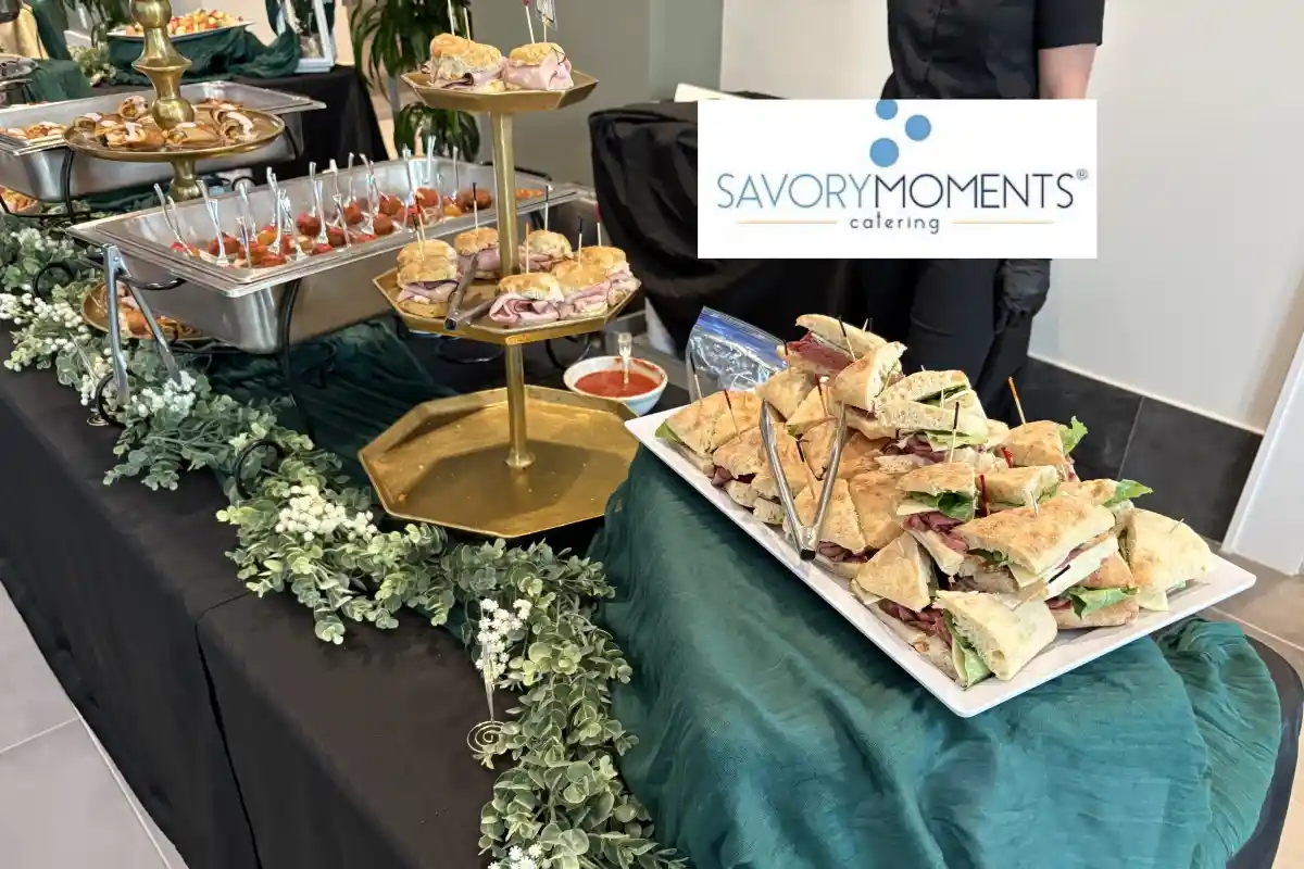 Catered food display and sandwich platters from Savory Moments Catering event setup