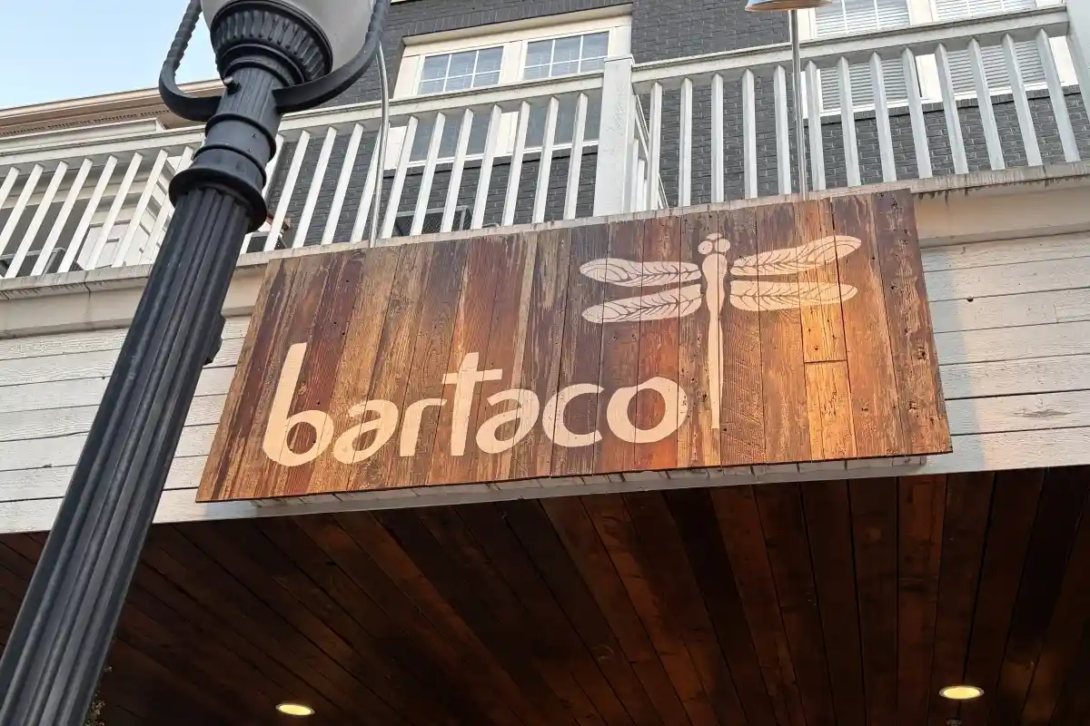 Wooden bartaco restaurant sign mounted above the entrance