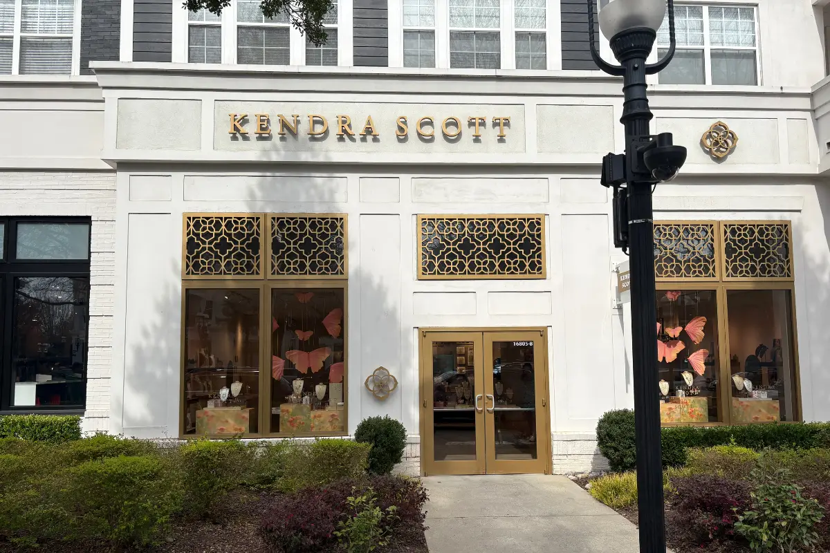 Entrance and branded sign for Kendra Scott storefront