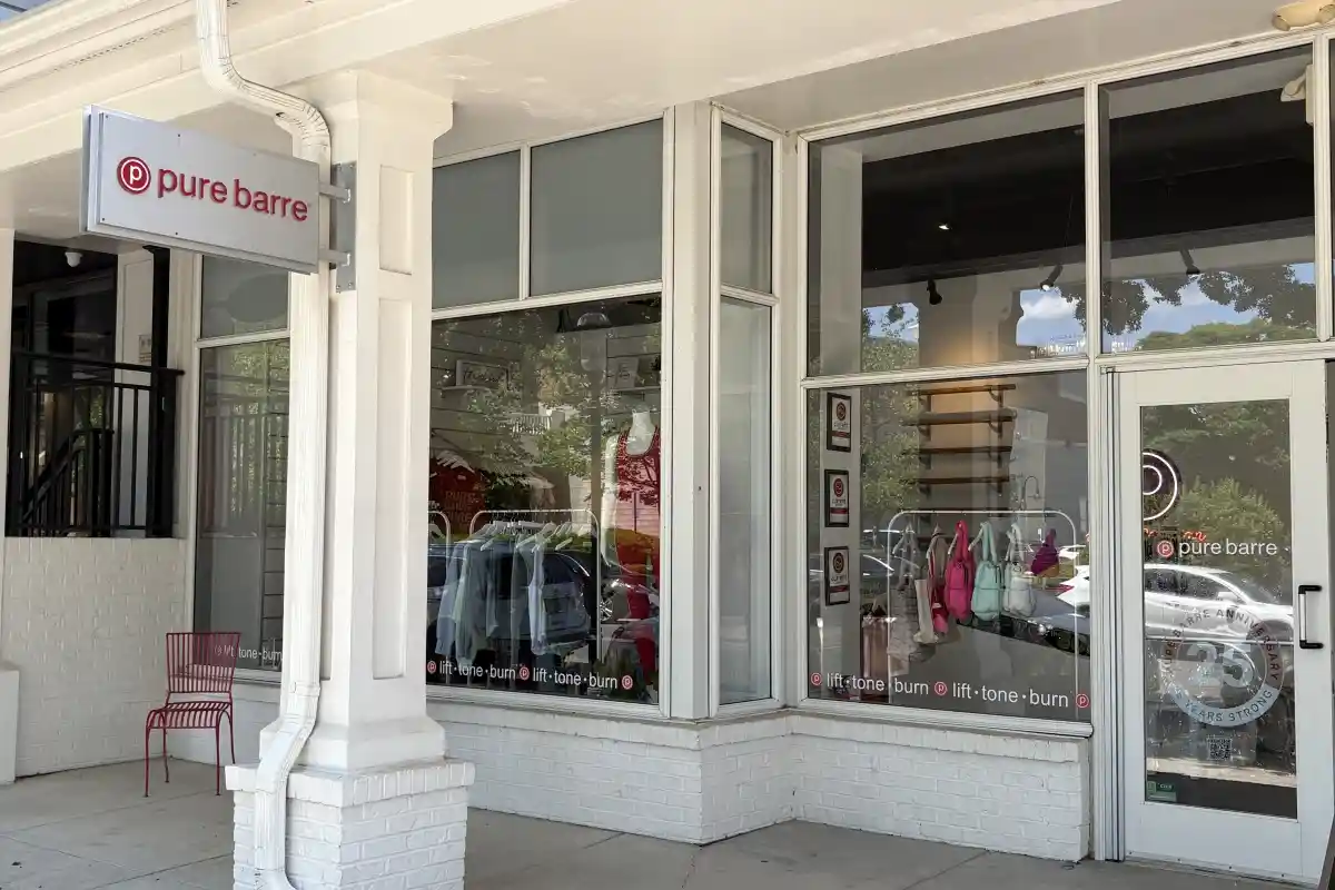 Storefront entrance to Pure Barre with store windows and sign