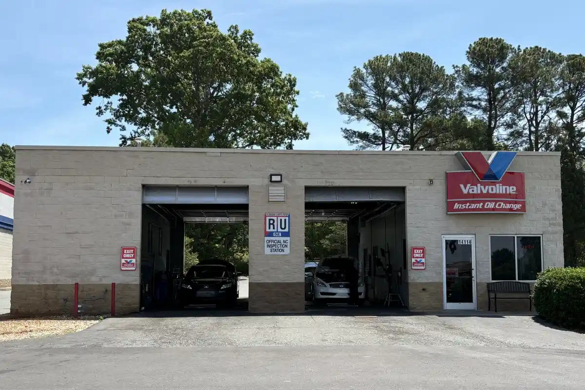 Open garage bays with cars getting serviced at Valvoline Instant Oil Change