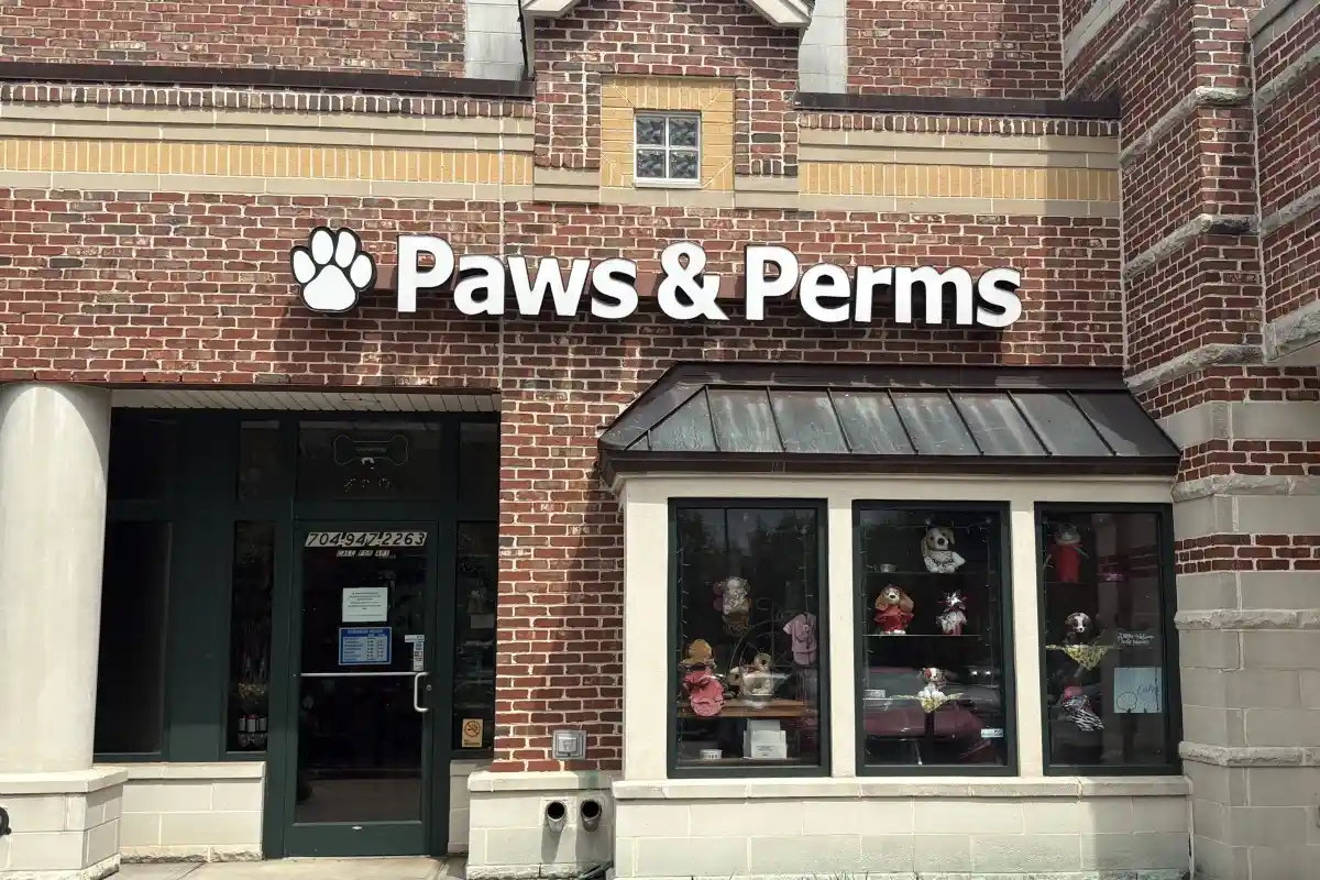 Front entrance doorway and sign for Paw & Perms