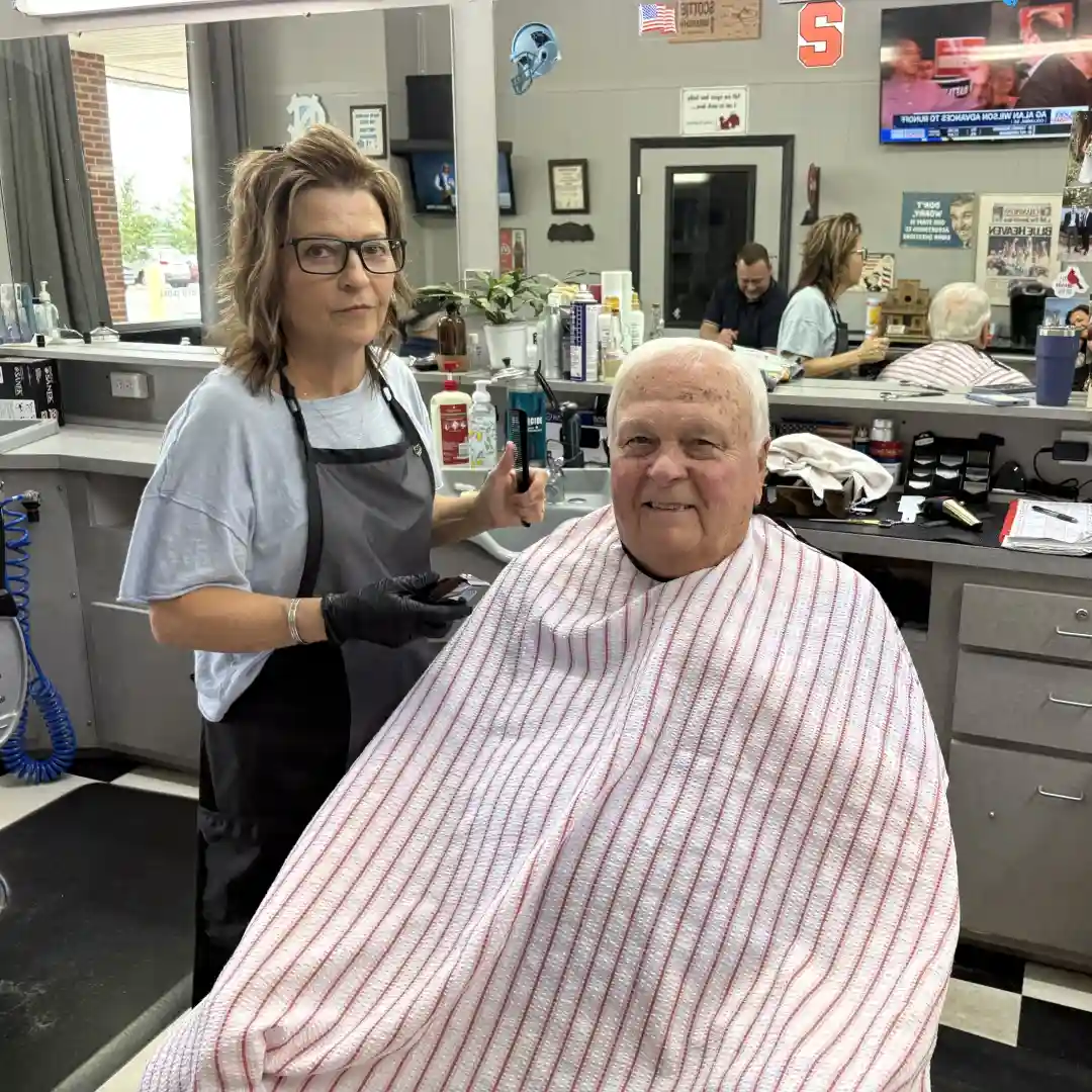Leslie cutting a customer's hair at Scottie's Barber Shop
