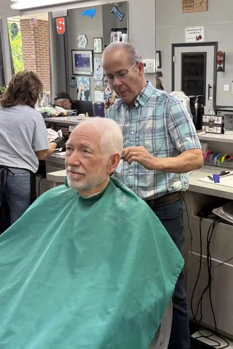 Gary Carter cutting hair at Scottie's Barber Shop in Huntersville