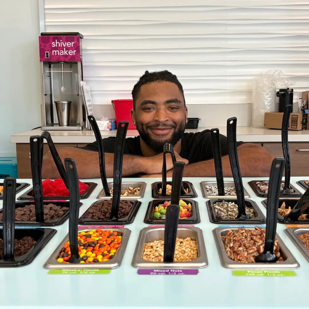 Staff member behind the toppings bar at TCBY Rosedale in Huntersville NC