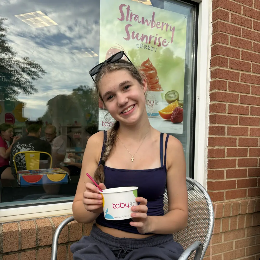 Customer enjoying frozen yogurt outside TCBY Rosedale