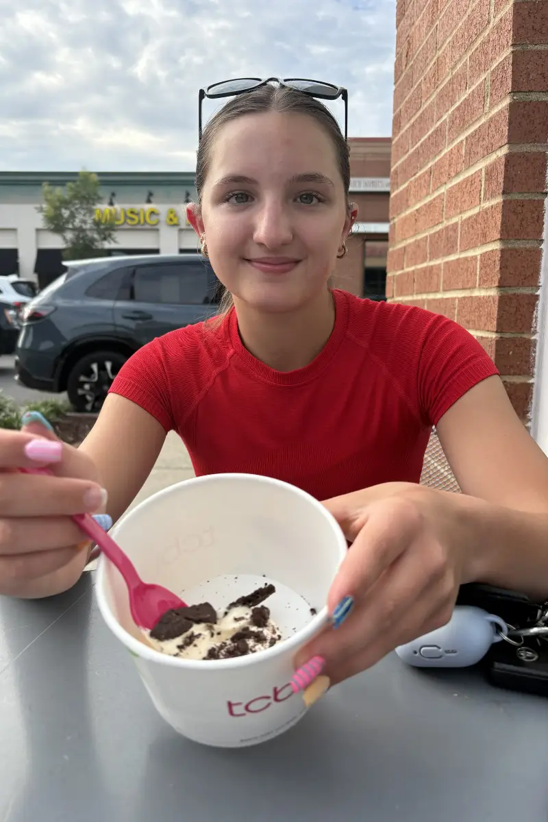 Customer enjoying frozen yogurt at outdoor seating at TCBY Rosedale
