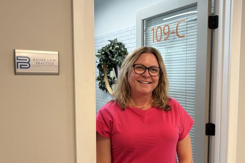 Tammy Bauer standing outside the office door of Bauer Law Practice