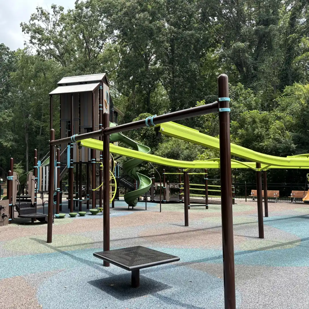 Zip line track curving through the treehouse-style playground at Rosedale Nature Park