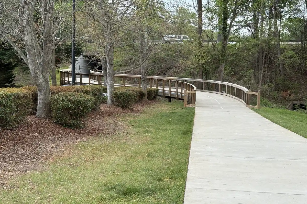 Torrence Creek Greenway paved path running through grassy area