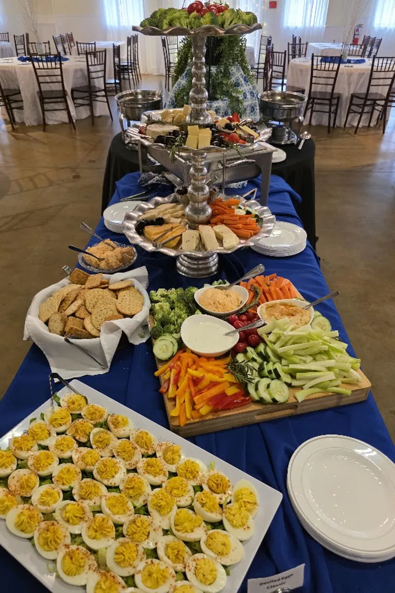 Appetizer spread with deviled eggs, cheese, and vegetables at a Magnolia Woods event