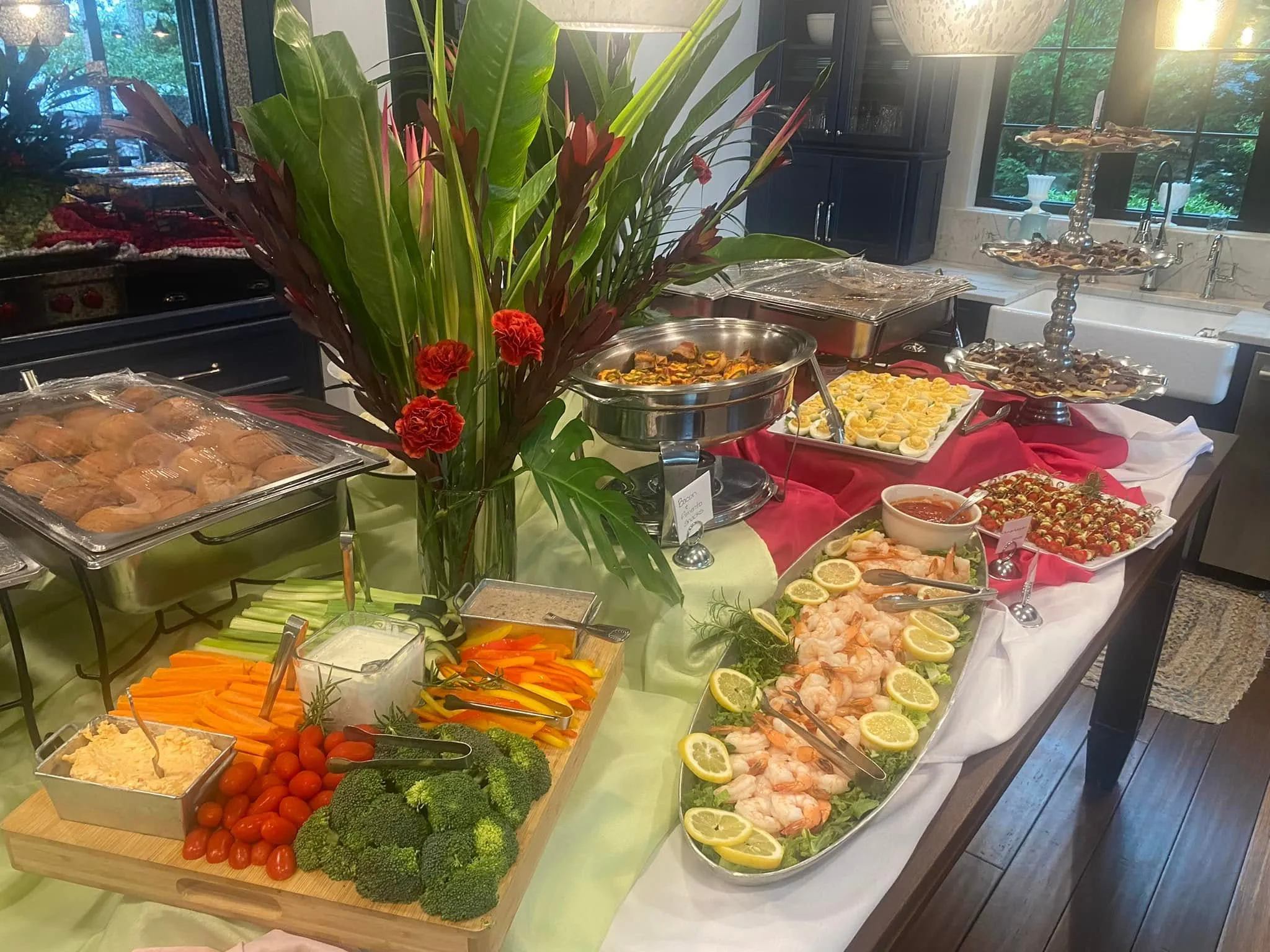 Appetizer spread with shrimp, deviled eggs, and a vegetable tray from Savory Moments Catering