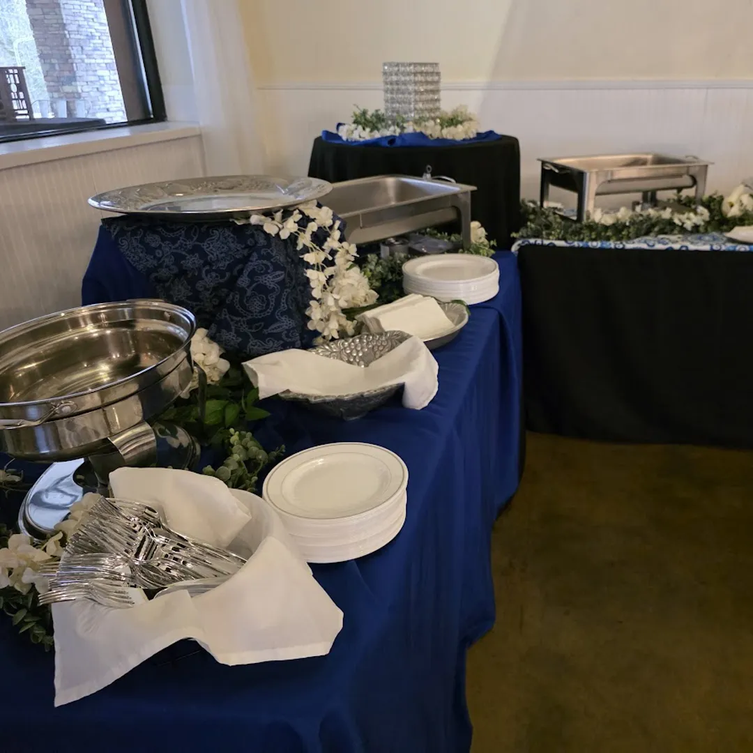 Full catering setup with chafers and floral accents from Savory Moments Catering