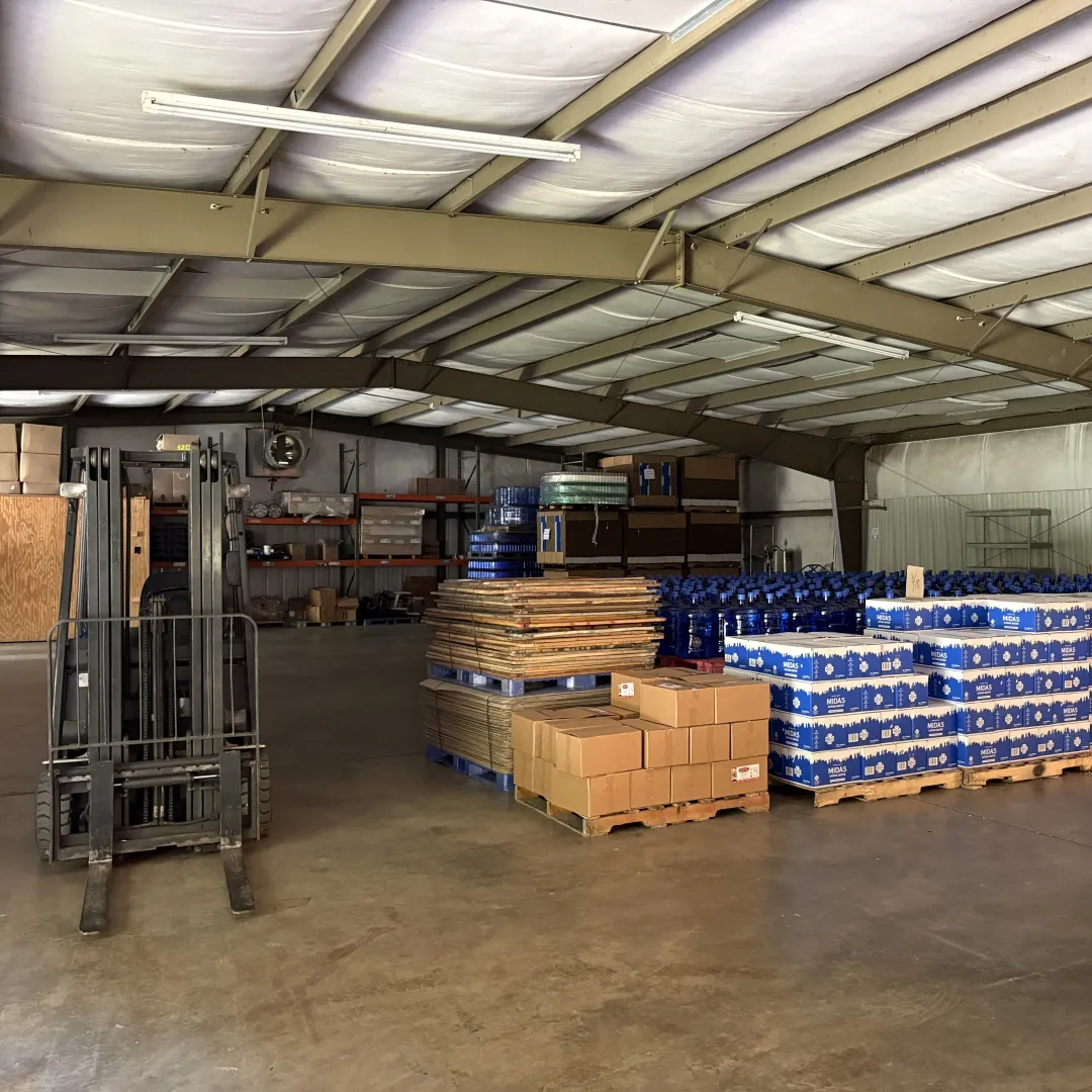 Warehouse of the Midas Spring Water with stacked product and forklift