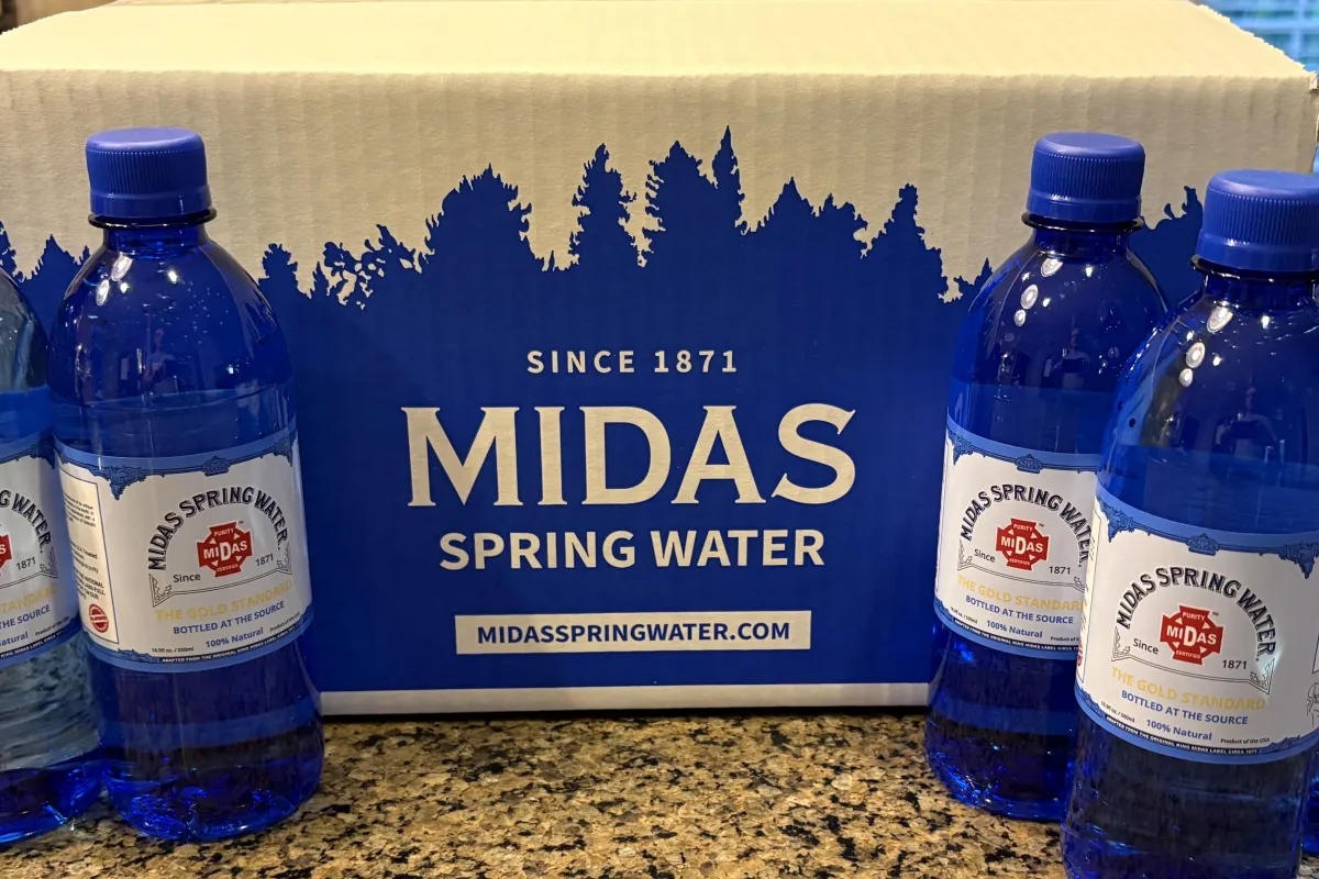 Case of Midas Spring Water 500ml bottles on a countertop