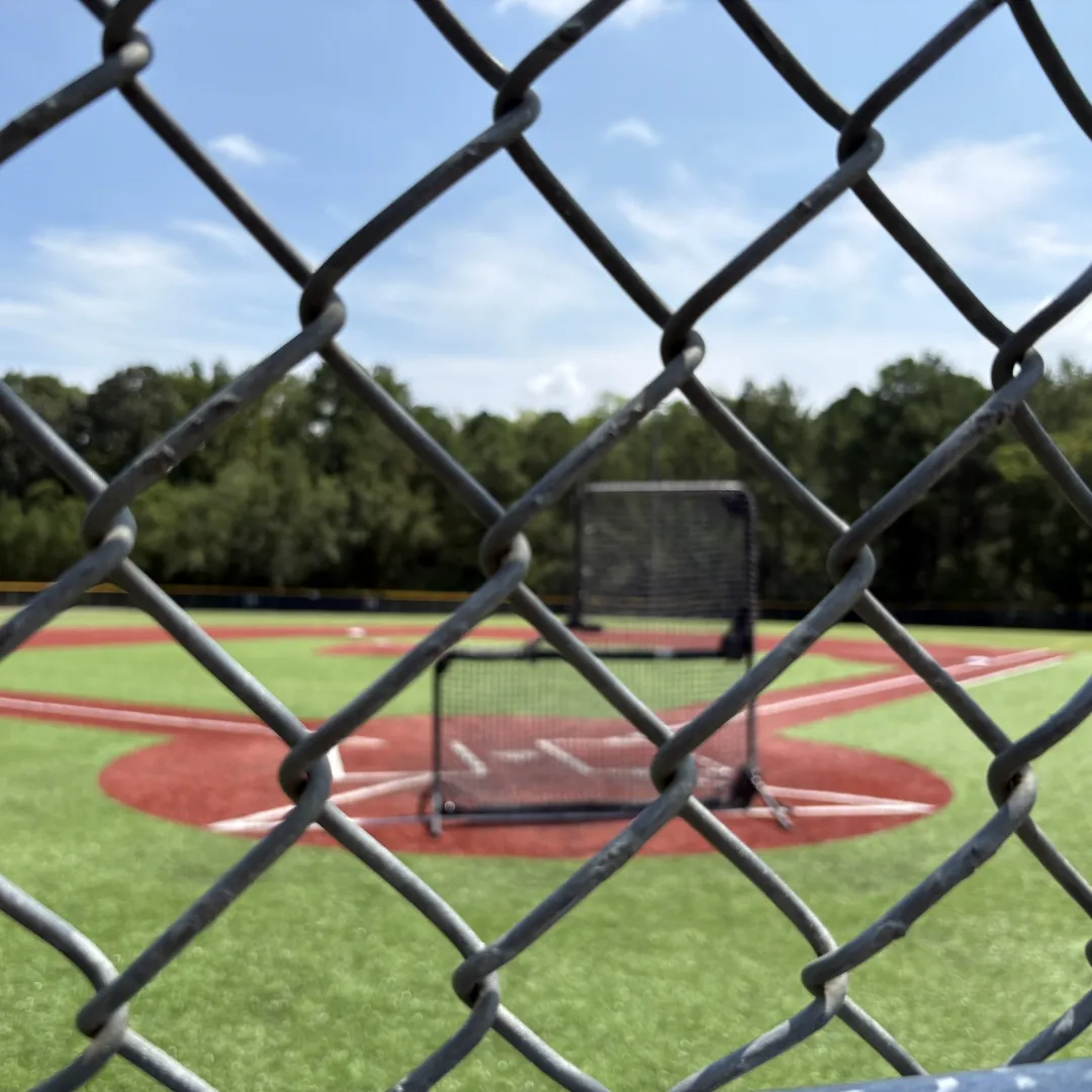 View of a baseball field through the chain-link fence at Huntersville Athletic Park