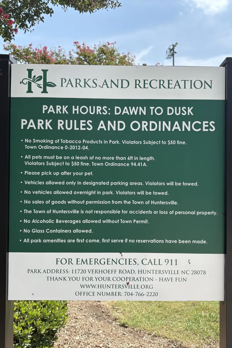 Posted park hours and rules sign at Huntersville Athletic Park