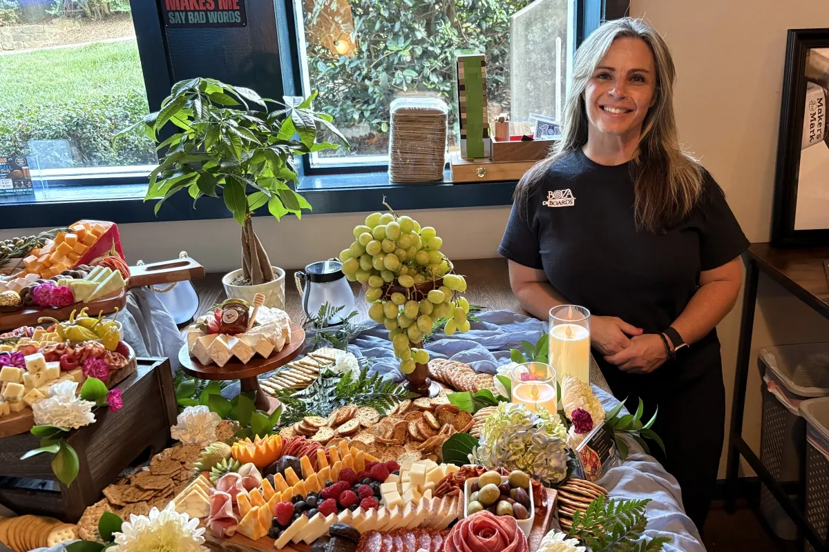 BozaBoard owner with a charcuterie board