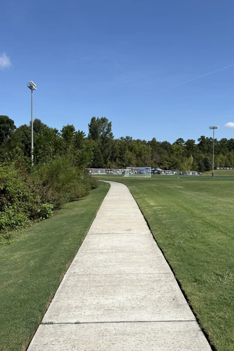 Paved walking trail alongside the fields at Richard Barry Memorial Park