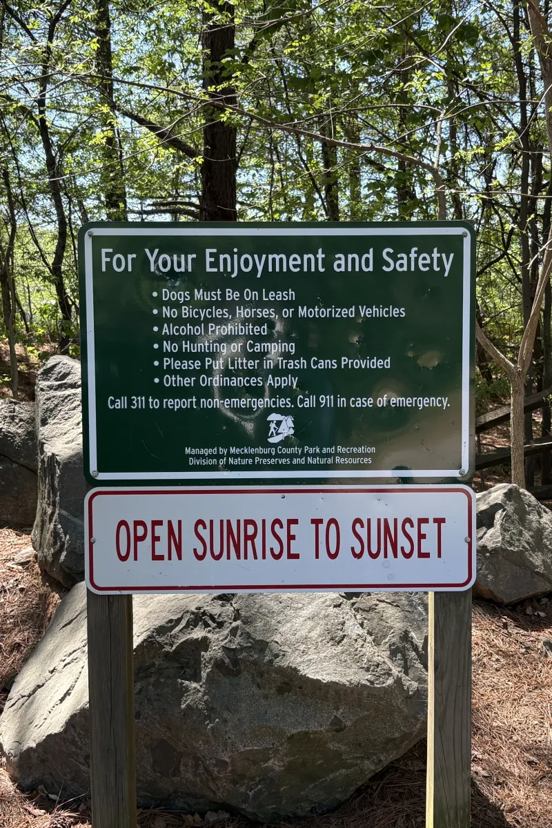 Posted rules and "Open Sunrise to Sunset" hours sign at Buckeye Cove Nature Preserve