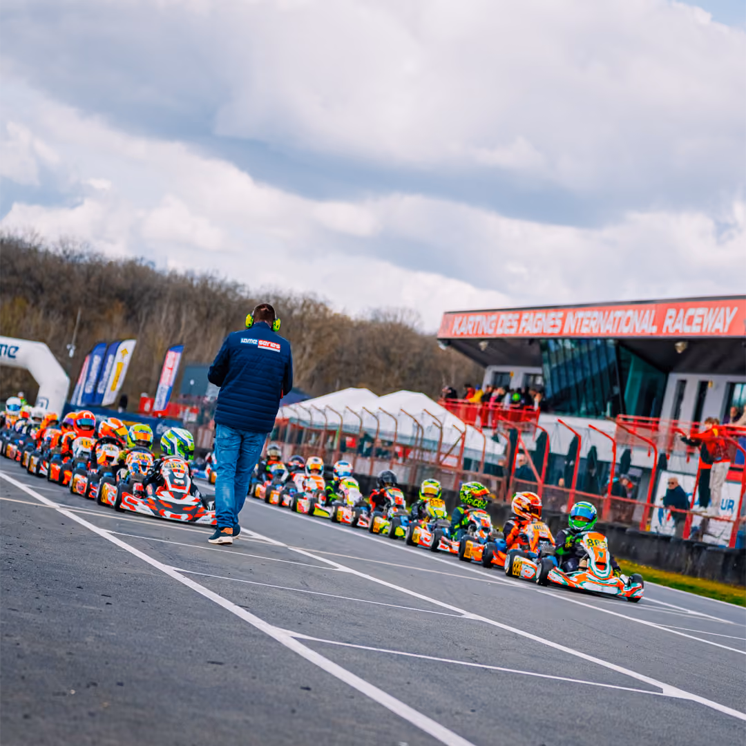 Karts lined up in the pit lane before a race in Mariembourg