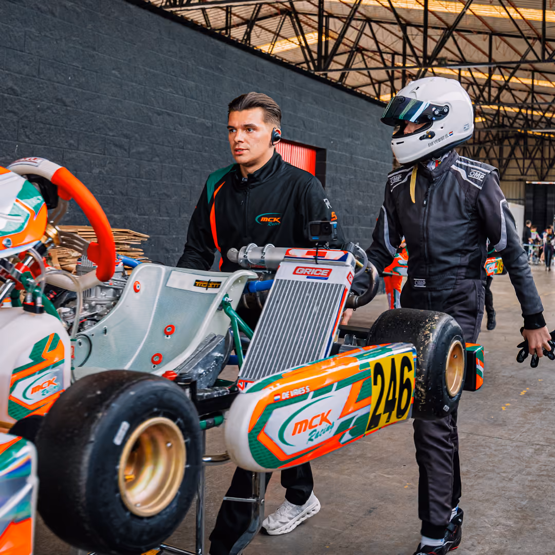 MCK Racing mechanic and driver with kart number 246 in the paddock in Zuera