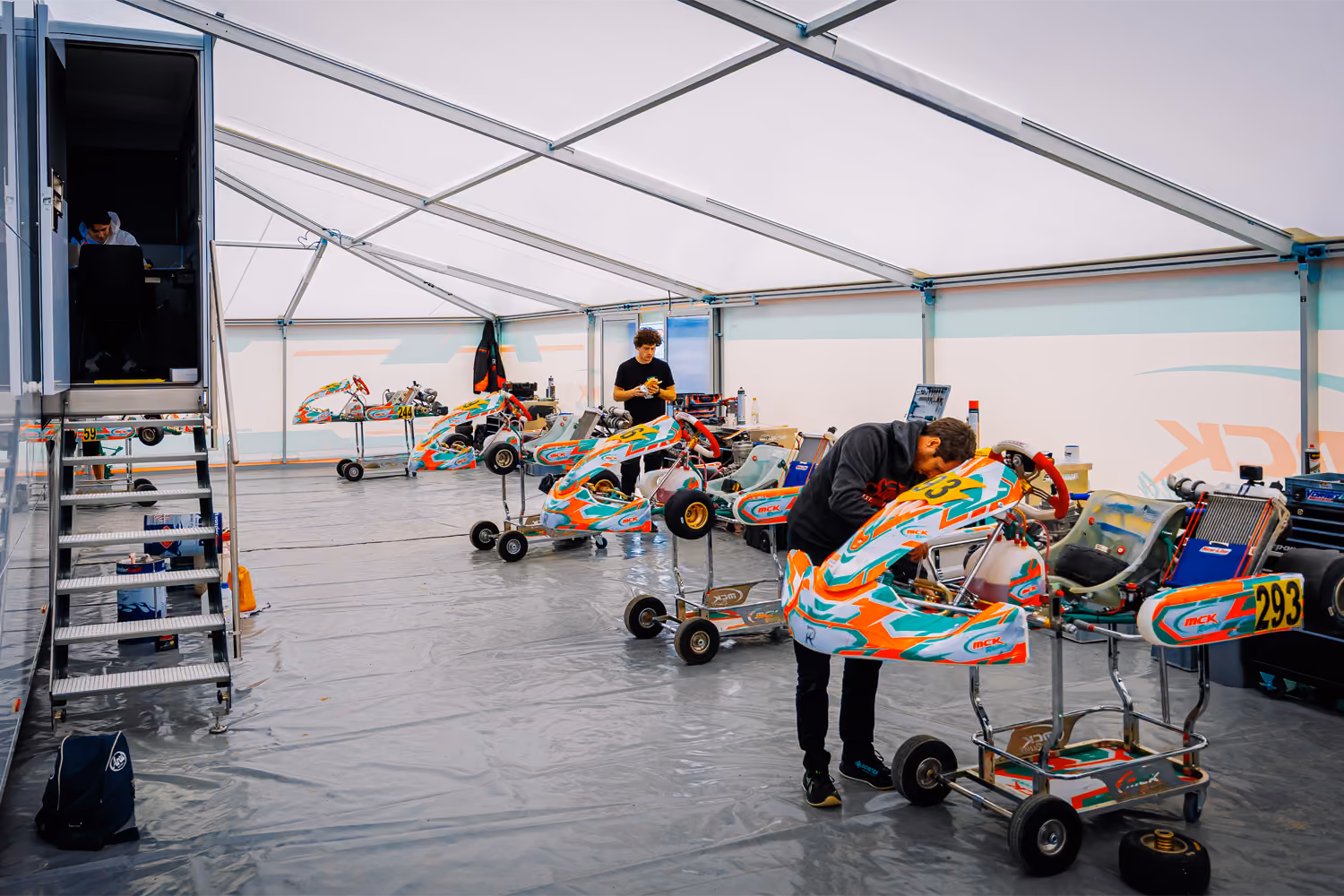 MCK Racing mechanics working on karts in the team tent