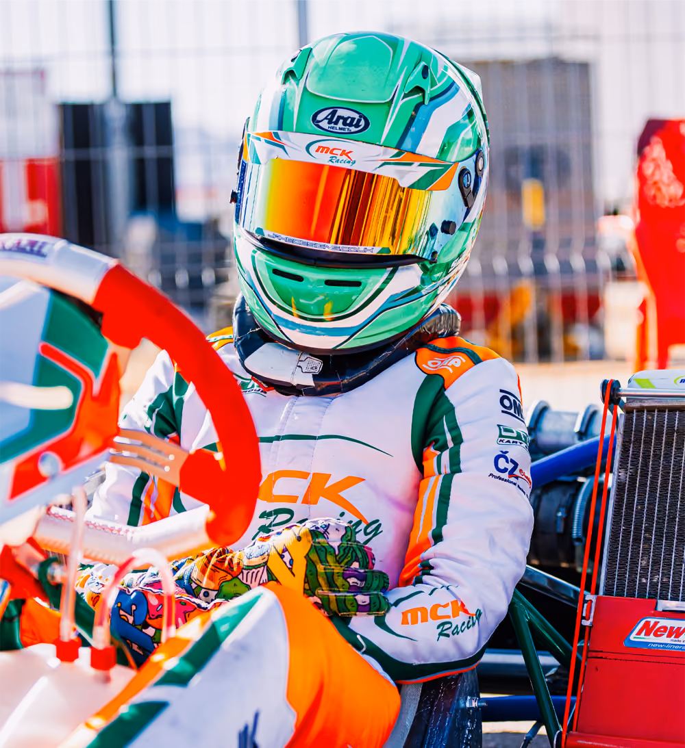 MCK Racing driver in green helmet seated in the kart in Valencia
