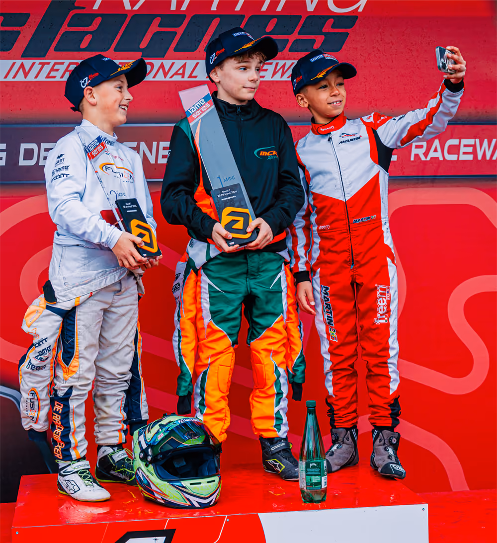 Young MCK Racing driver on the podium with trophy in Mariembourg