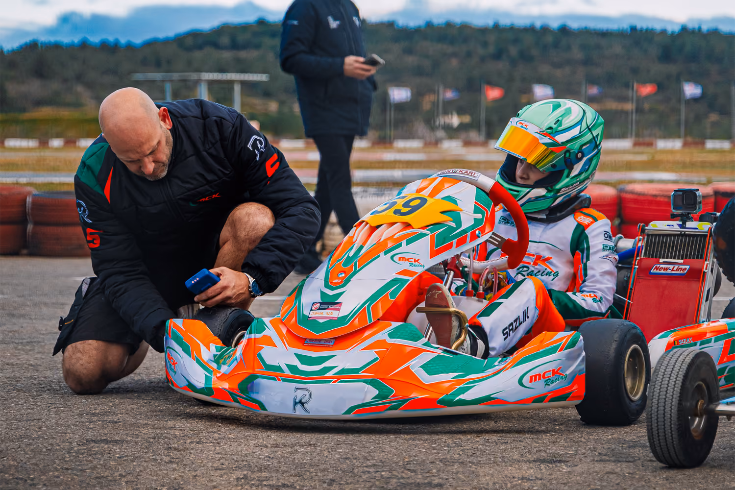 MCK Racing mechanic checking a kart on the grid in Valencia