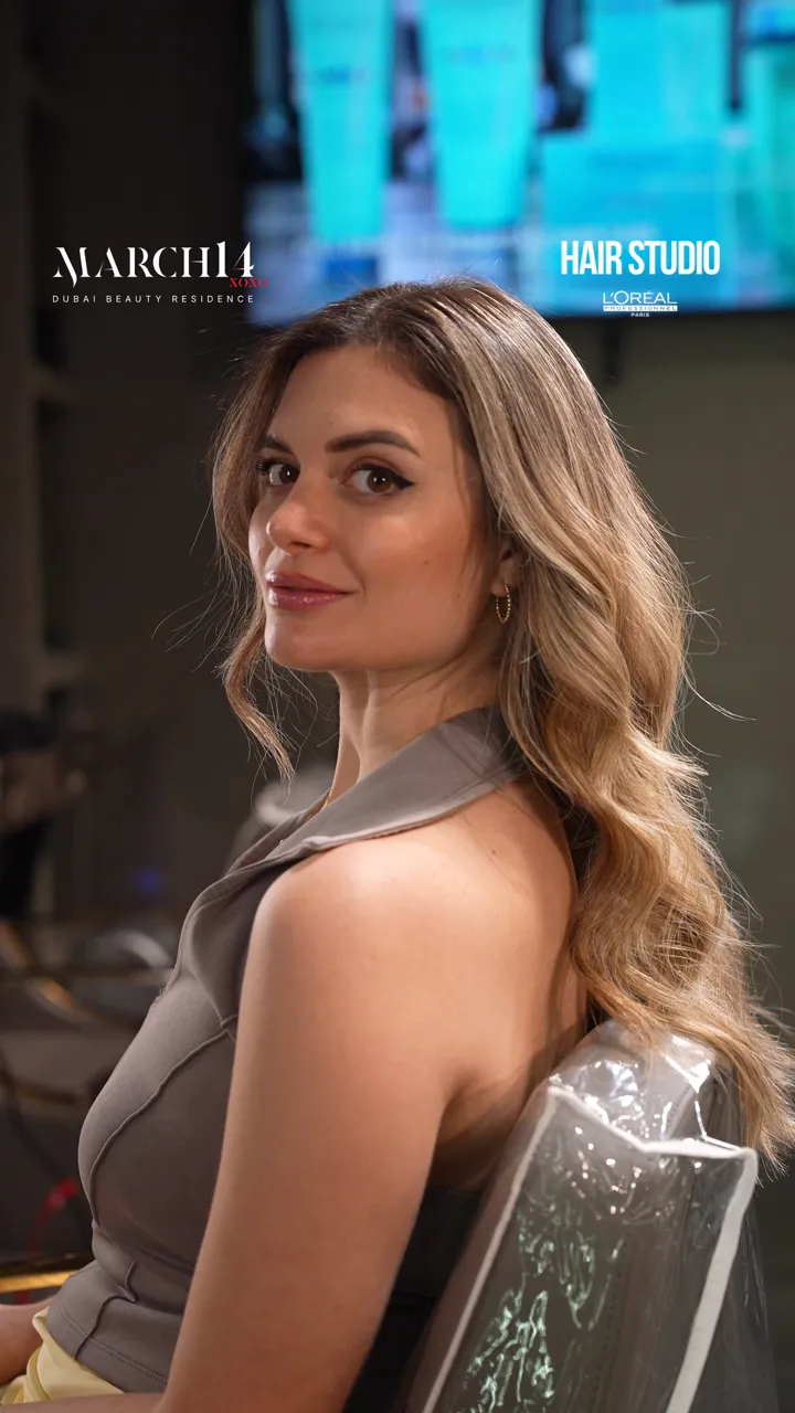 Golden blond highlights with soft waves at March14 Hair Studio, Dubai