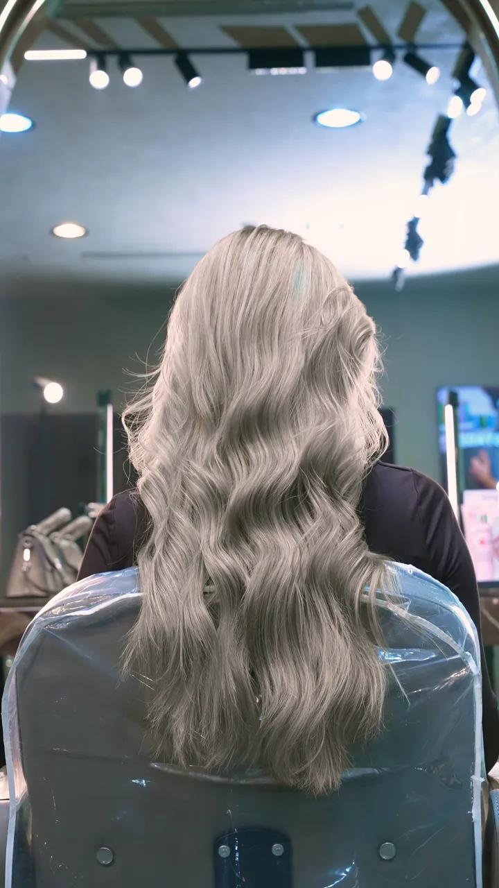 Ash blond highlights styled in long waves at March14 Hair Studio, Dubai