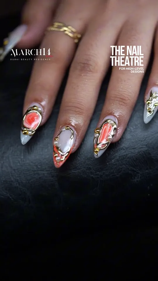 Orange and gold nail design at March14 nail salon in Dubai