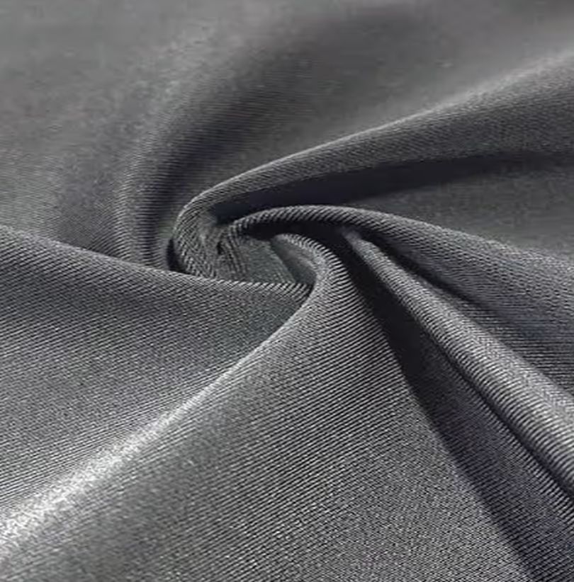 Close-up of textured dark gray fabric with a folded edge.
