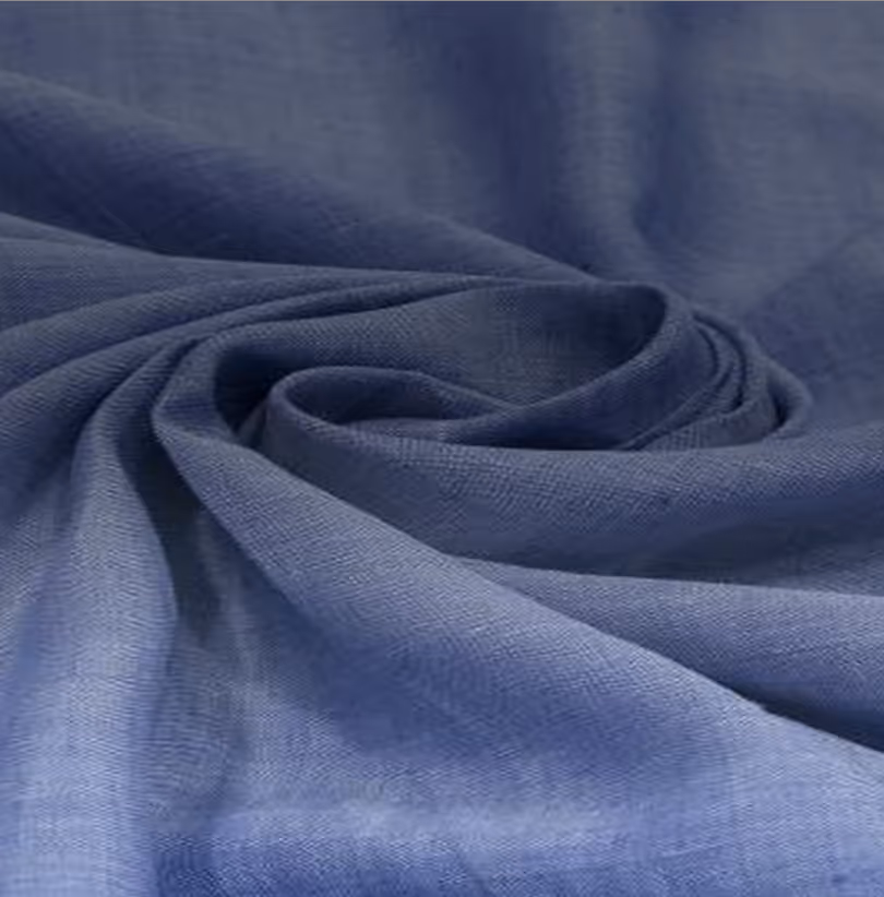 Close-up of folded light gray knit fabric with small colored speckles.