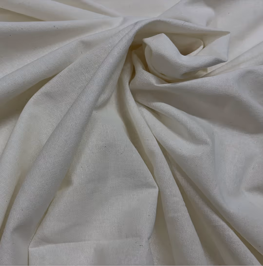 Close-up of green textured fabric with a fold showing its woven pattern.