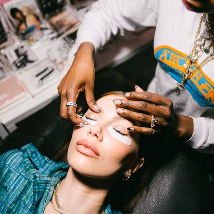 A lady getting her eye lashes prepared by a beautician