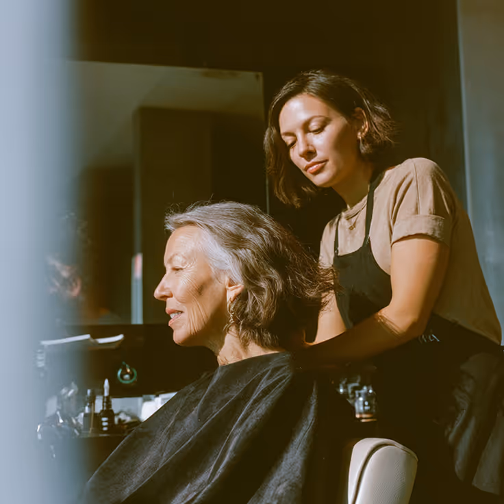 A lady getting her haircut at a salon
