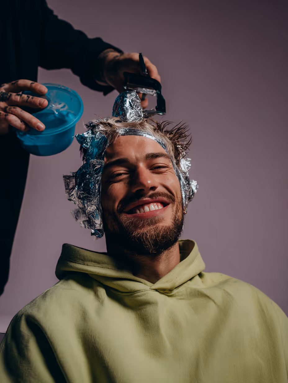 Close-up of a hand with glossy white almond-shaped nails against a light background.