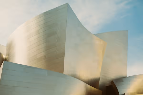 Disney Concert Hall reflecting the sky and evening clouds.