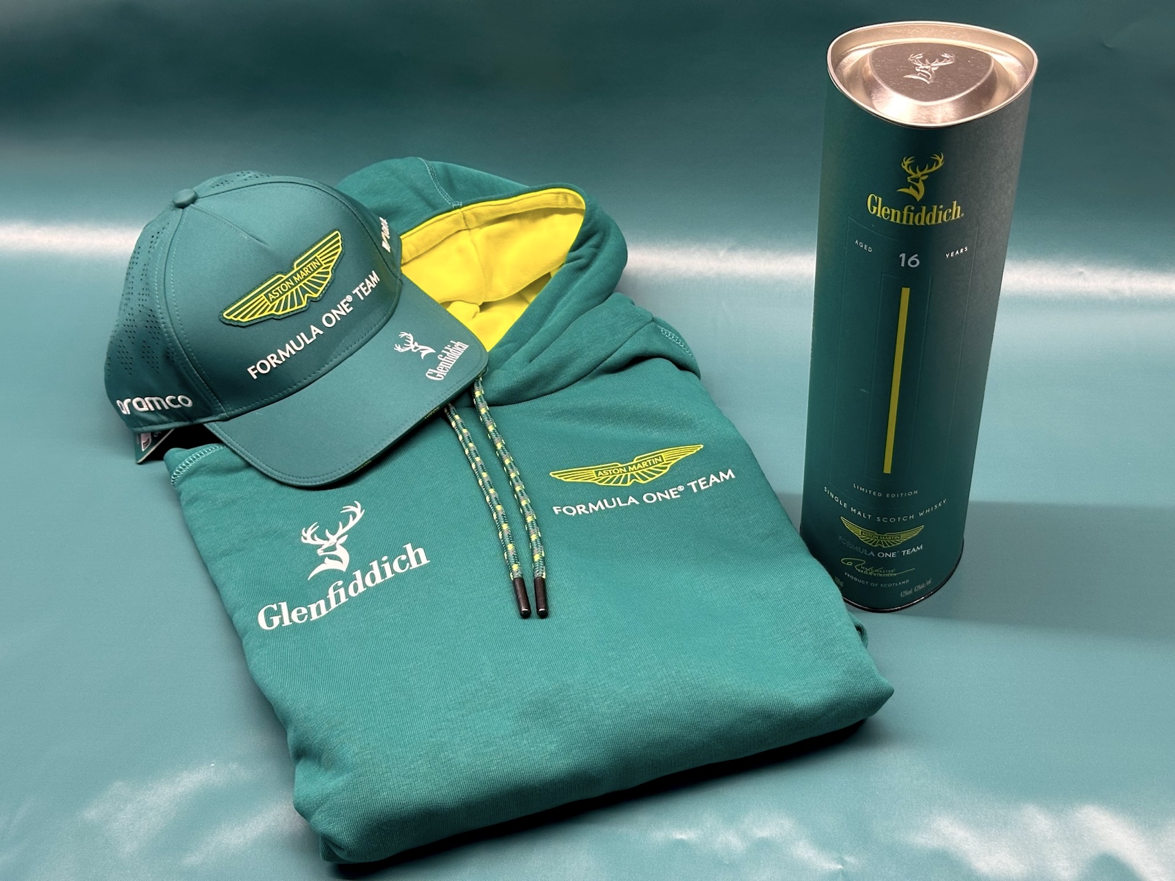 Branded hat, sweatshirt, and Glenfiddich scotch whiskey bottle for Formula One Team and Aston Martin