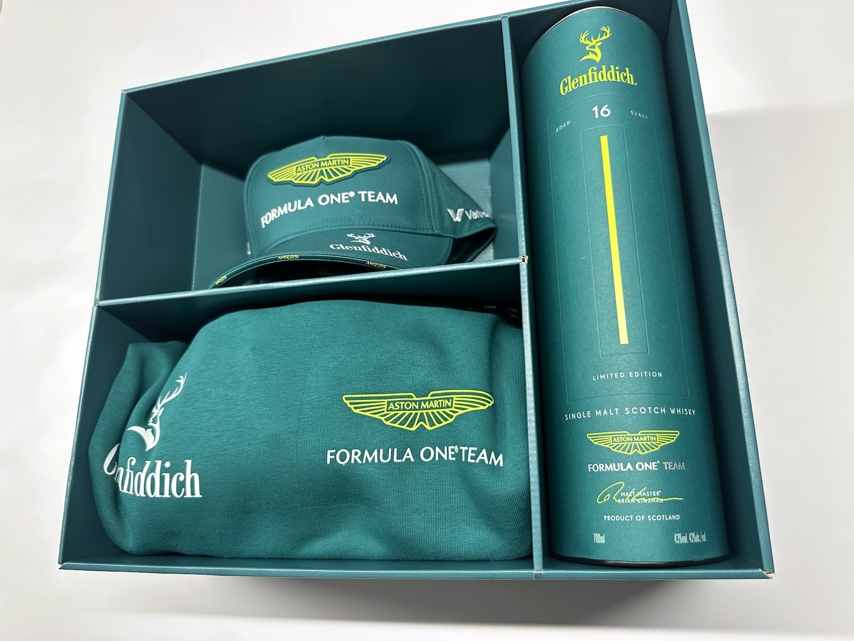 PR box with branded hat, sweatshirt, and Glenfiddich scotch whiskey bottle for Formula One Team and Aston Martin