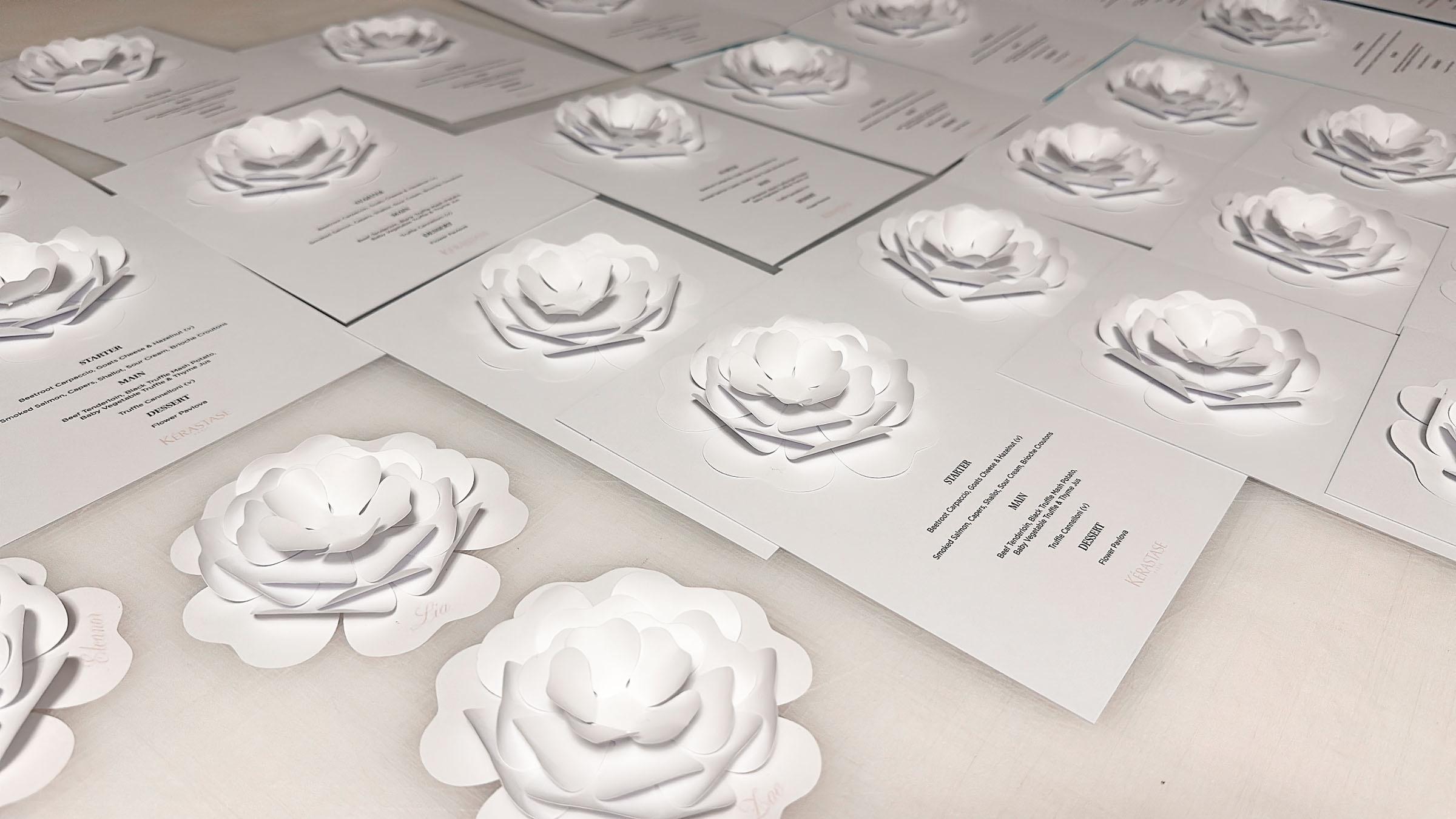 Paper engineering and bespoke invitations: Custom paper flowers on invitations for Kerastase