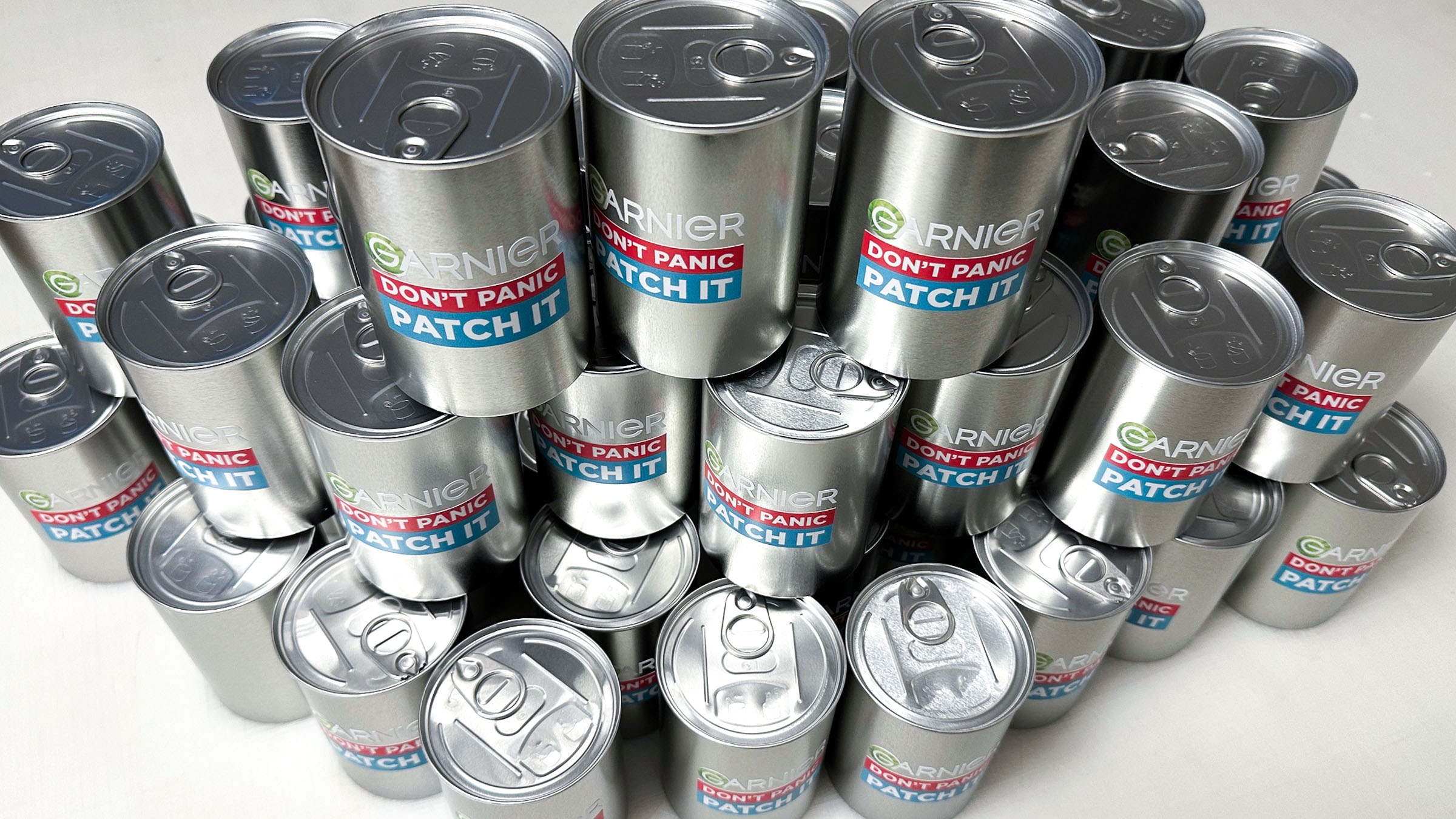 Custom branded tins for Garnier's "don't panic, patch it" campaign
