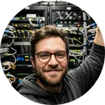 Candid photo of a satisfied IT technician in Cologne found via Express Jobs.