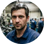 Realistic portrait of a focused CNC operator in a workshop in Stuttgart.