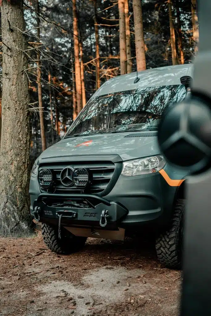 Overland campervan front view parked in forest trail