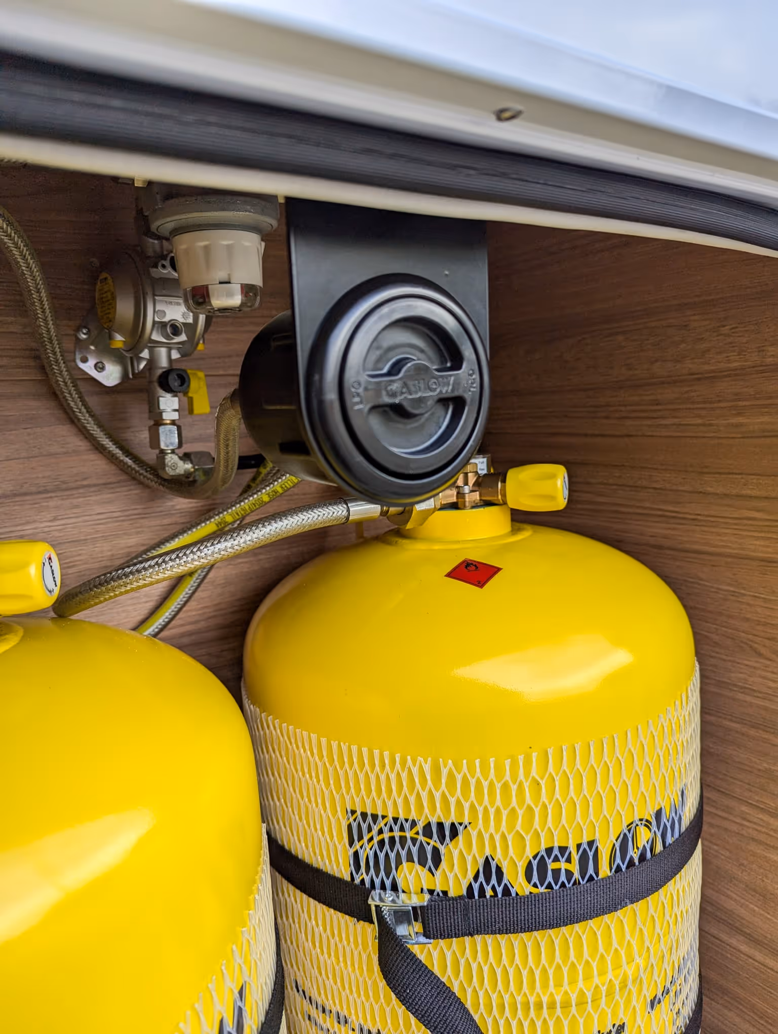 Refillable LPG gas bottles installed in motorhome storage compartment