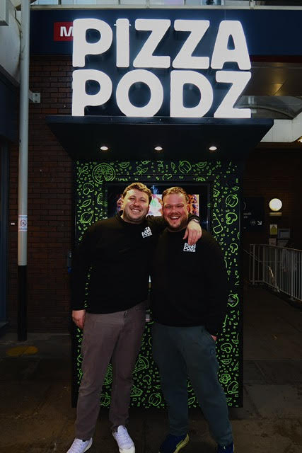 Chef placing cheese on raw pizza bread
