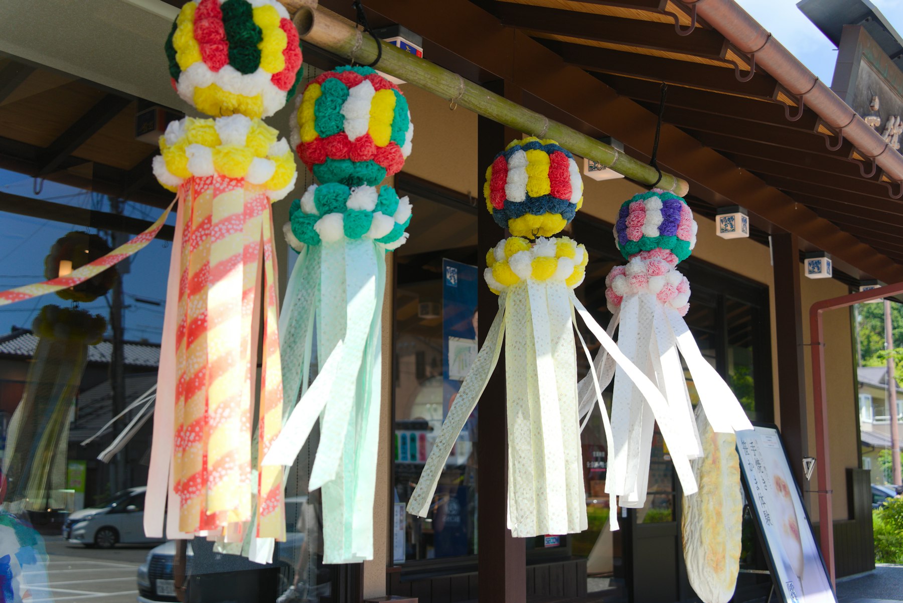 Colourful Tanabata streamers hanging under a roof in Matsushima, Miyagi